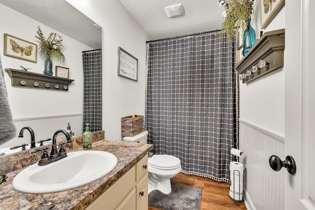 1464 Fieldstone Ct, Winder, GA 30680 - full bath with vanity, wood finished floors, a wainscoted wall, curtained shower, and a textured ceiling