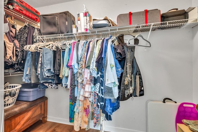 1464 Fieldstone Ct, Winder, GA 30680 - walk in closet featuring wood finished floors