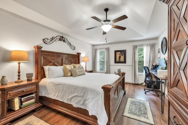 1464 Fieldstone Ct, Winder, GA 30680 - bedroom featuring a tray ceiling, wood finished floors, a desk, crown molding, and ceiling fan