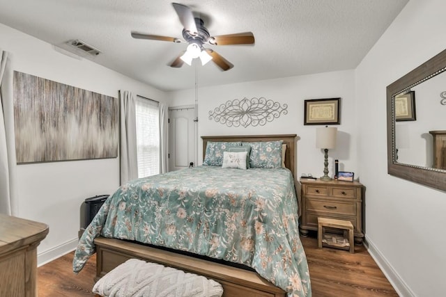 1464 Fieldstone Ct, Winder, GA 30680 - bedroom with wood finished floors, a textured ceiling, and a ceiling fan