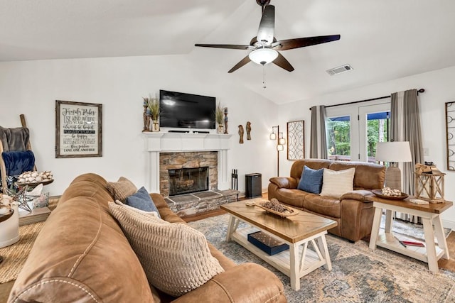 1464 Fieldstone Ct, Winder, GA 30680 - living area featuring lofted ceiling, a stone fireplace, and ceiling fan
