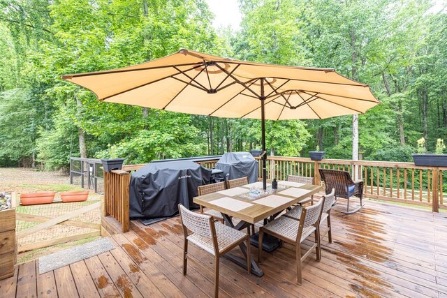 1464 Fieldstone Ct, Winder, GA 30680 - wooden terrace featuring outdoor dining space, a forest view, and area for grilling