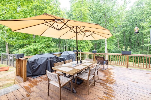 1464 Fieldstone Ct, Winder, GA 30680 - wooden terrace with outdoor dining space, area for grilling, and a forest view
