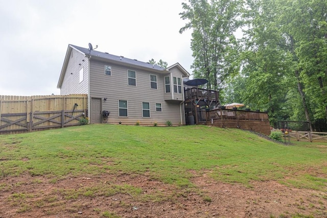 1464 Fieldstone Ct, Winder, GA 30680 - back of property with a fenced backyard, a wooden deck, and a gate