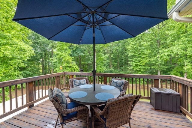 1464 Fieldstone Ct, Winder, GA 30680 - wooden deck with outdoor dining space and a forest view