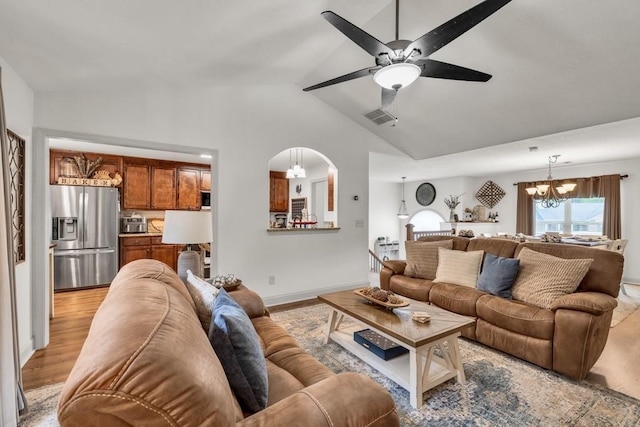 1464 Fieldstone Ct, Winder, GA 30680 - living area with a chandelier, lofted ceiling, ceiling fan, and light wood finished floors