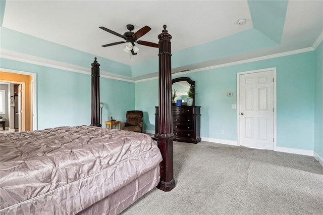 bedroom featuring carpet, baseboards, a raised ceiling, ornamental molding, and a ceiling fan