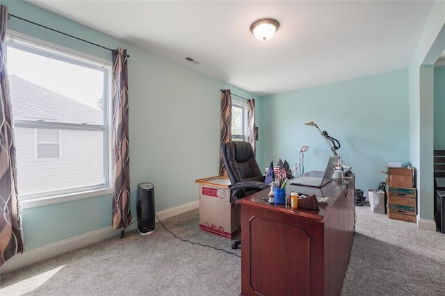 carpeted home office featuring baseboards