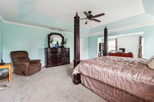 carpeted bedroom featuring a tray ceiling, baseboards, and a ceiling fan