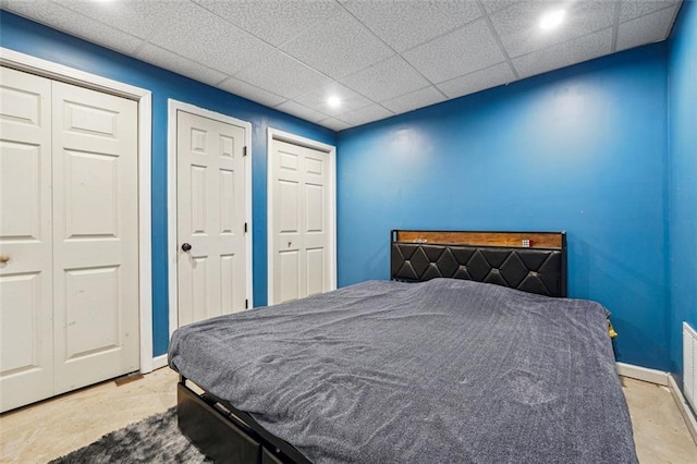 bedroom with baseboards, recessed lighting, and multiple closets