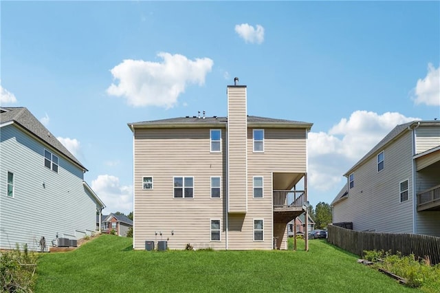 rear view of property featuring a chimney and central AC