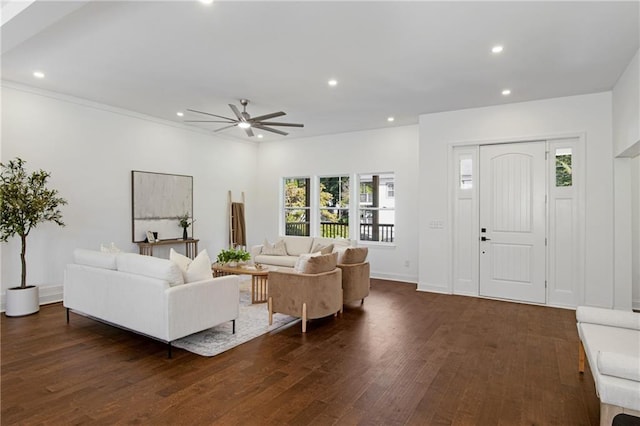 living room featuring dark wood-type flooring and ceiling fan