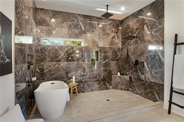 bathroom with tile walls, tile patterned flooring, and plus walk in shower