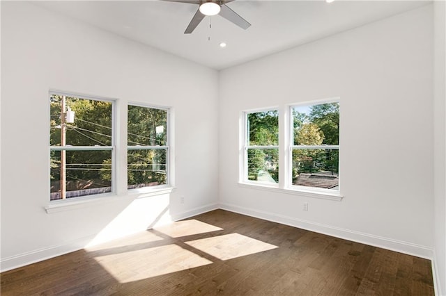 spare room featuring ceiling fan and dark hardwood / wood-style floors