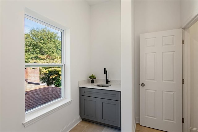 interior space featuring tile patterned floors, a wealth of natural light, and vanity