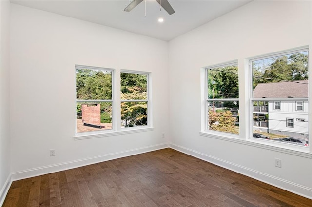 spare room with dark wood-type flooring and ceiling fan