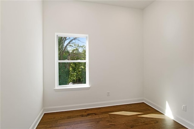 unfurnished room featuring dark hardwood / wood-style flooring