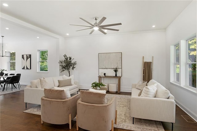 living room featuring dark wood-type flooring, ceiling fan, and ornamental molding