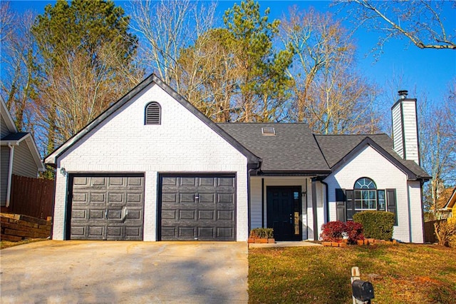 view of front facade featuring a garage and a front lawn