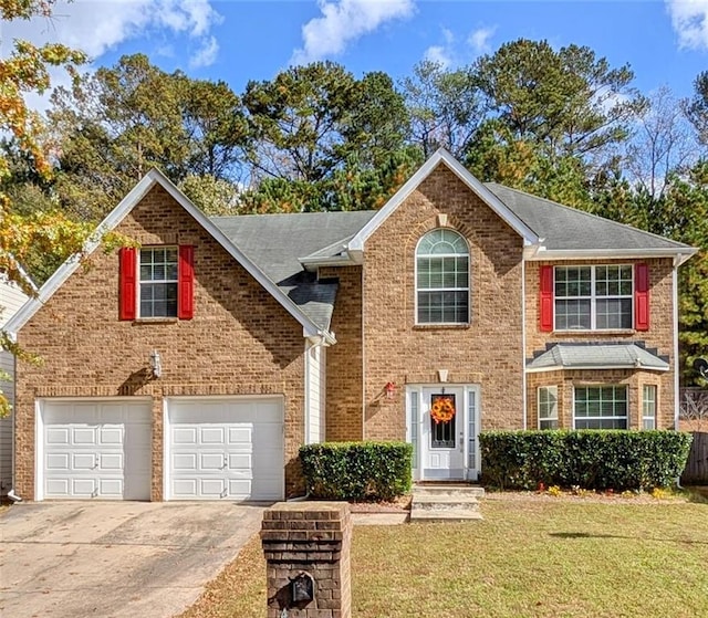 view of front of house featuring a front lawn and a garage