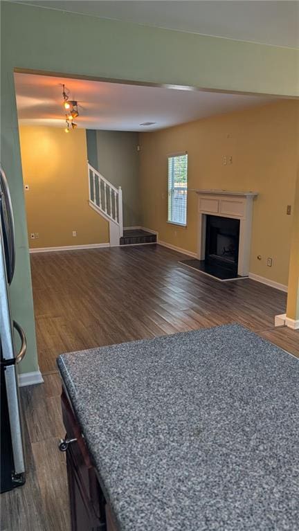 unfurnished living room with dark hardwood / wood-style floors