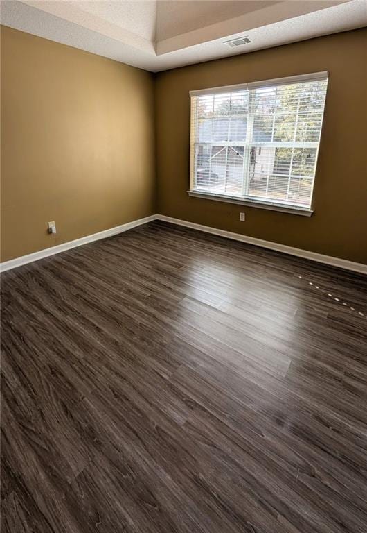 spare room featuring dark hardwood / wood-style flooring