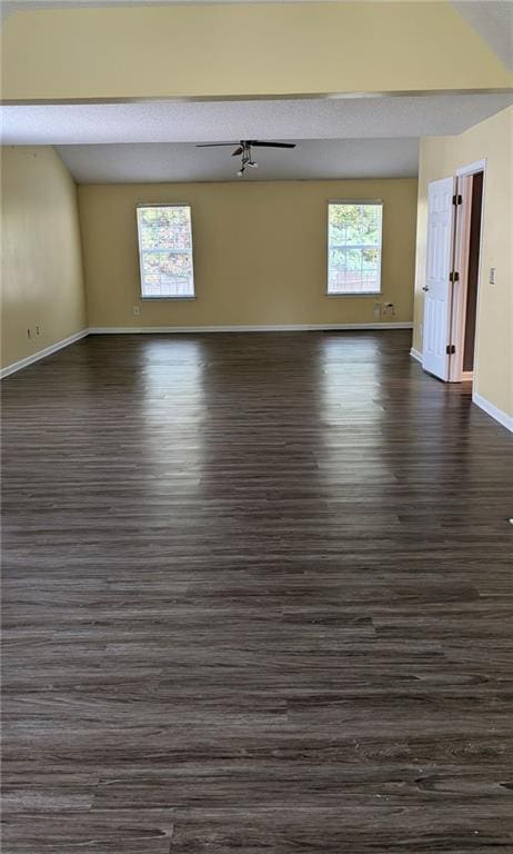 unfurnished room featuring a textured ceiling and dark hardwood / wood-style flooring