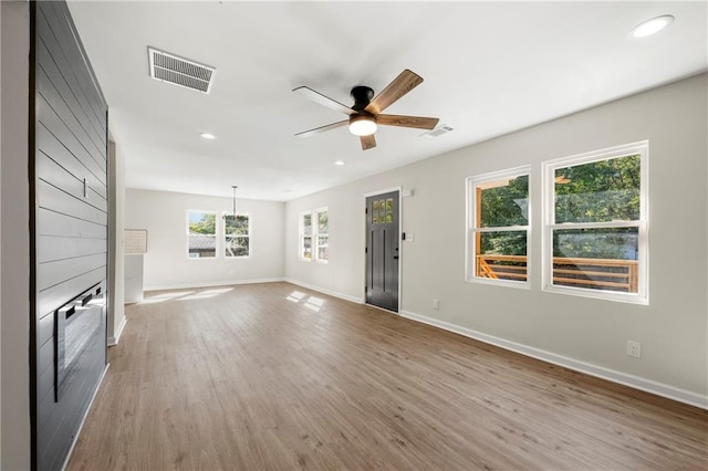 unfurnished living room with hardwood / wood-style floors and ceiling fan