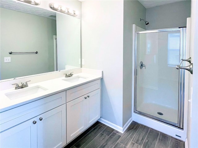 bathroom with vanity and a shower with shower door