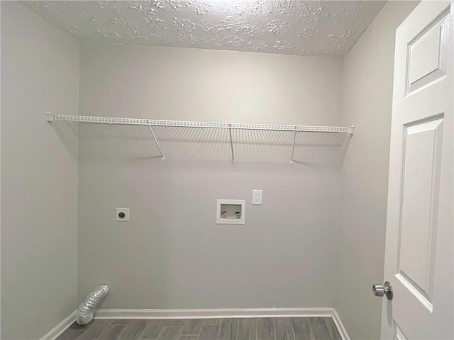 laundry room featuring electric dryer hookup, dark hardwood / wood-style floors, washer hookup, and a textured ceiling