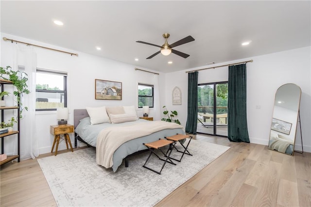 bedroom with access to exterior, recessed lighting, multiple windows, and light wood-style floors