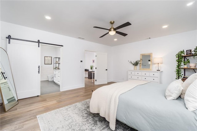 bedroom with baseboards, a barn door, recessed lighting, light wood-style flooring, and a ceiling fan