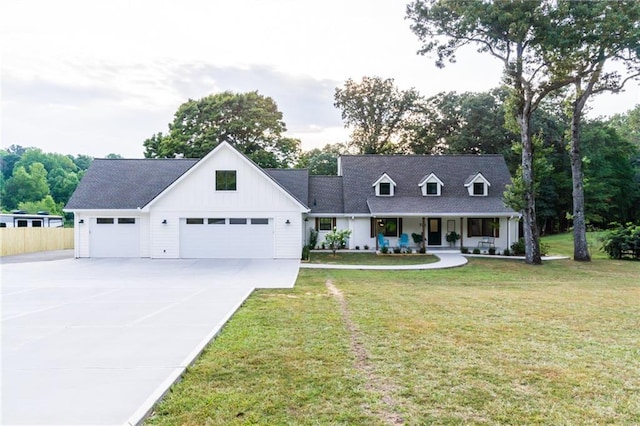 view of front of property with driveway, board and batten siding, covered porch, an attached garage, and a front yard