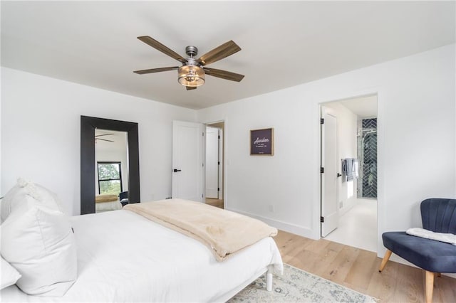 bedroom with a ceiling fan, light wood-style floors, and baseboards