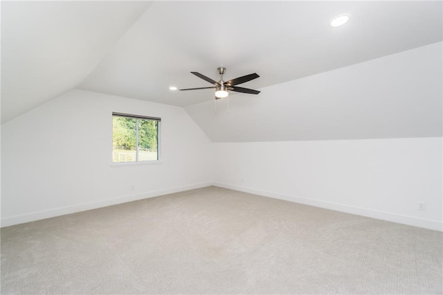 additional living space featuring baseboards, lofted ceiling, light carpet, recessed lighting, and a ceiling fan