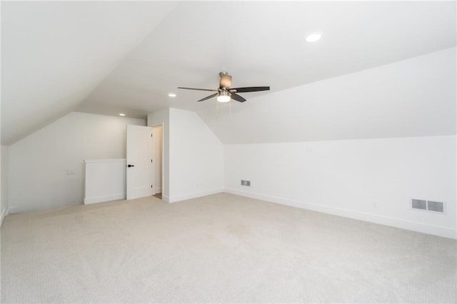 additional living space featuring visible vents, light carpet, recessed lighting, lofted ceiling, and ceiling fan