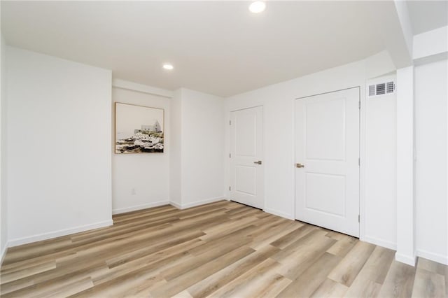 unfurnished bedroom with recessed lighting, visible vents, light wood-style flooring, and baseboards