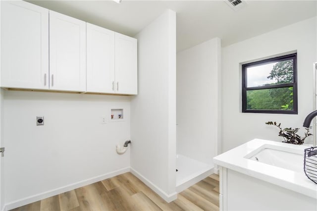 laundry area featuring hookup for a washing machine, visible vents, hookup for an electric dryer, cabinet space, and a sink