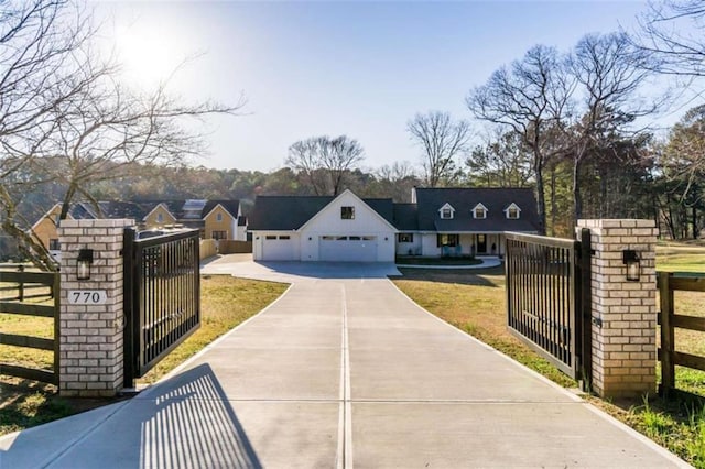 view of front facade featuring a gate, an attached garage, concrete driveway, a front lawn, and a fenced front yard