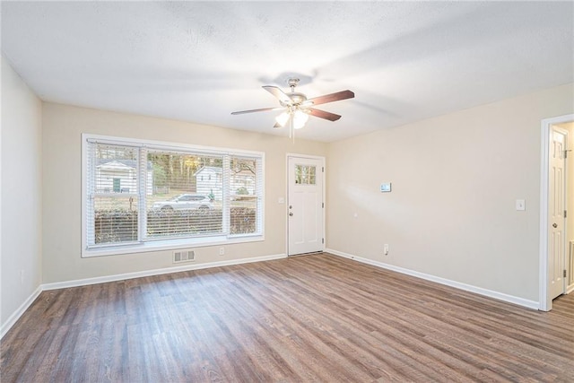 empty room featuring ceiling fan and hardwood / wood-style flooring