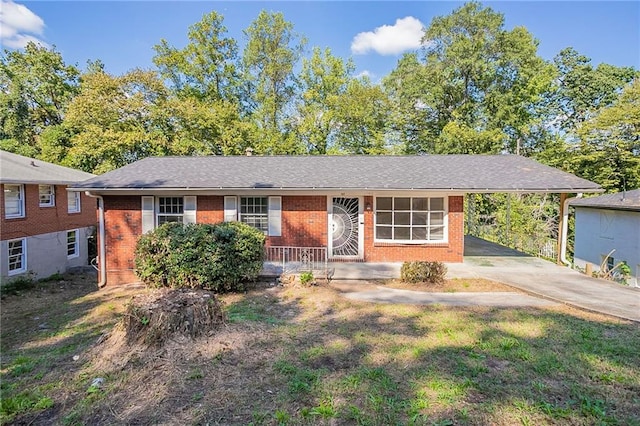 ranch-style home with a front yard and a carport