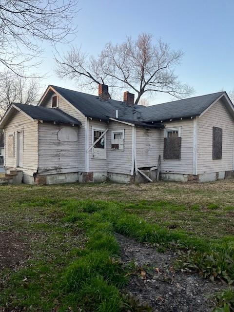 rear view of property with a yard