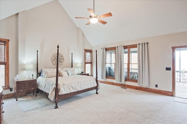 carpeted bedroom with ceiling fan and high vaulted ceiling