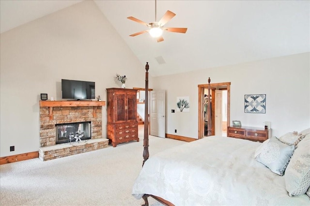 bedroom with a walk in closet, carpet, high vaulted ceiling, and a fireplace