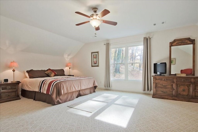 carpeted bedroom featuring lofted ceiling and ceiling fan