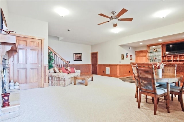 living room featuring light colored carpet and ceiling fan