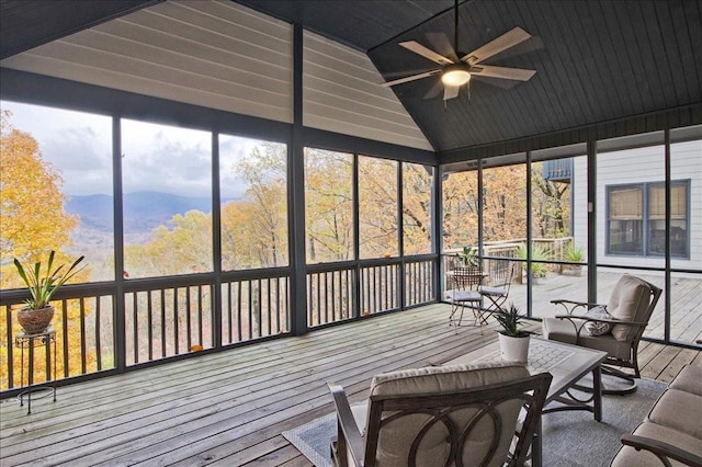 sunroom featuring ceiling fan, vaulted ceiling, and a healthy amount of sunlight