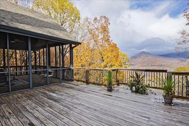 wooden terrace featuring a mountain view and a sunroom