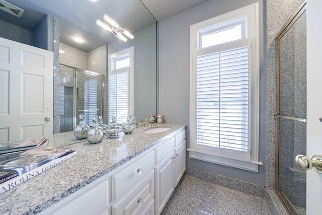 full bath featuring visible vents, a stall shower, and vanity