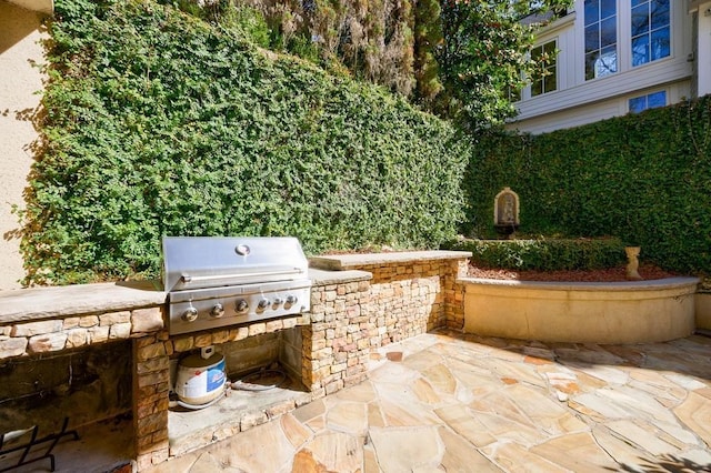 view of patio with exterior kitchen and grilling area